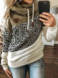Close-up detail of a women's color-blocked cowl neck hoodie with leopard print
