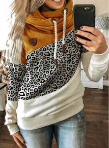 Close-up of a women's color-block cowl neck hoodie with leopard print and drawstring