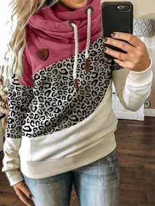Detailed view of women's cowl neck hoodie featuring leopard print color-block panels