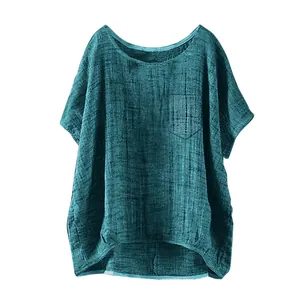 Close-up of women's casual loose linen top in teal featuring chest pocket detail