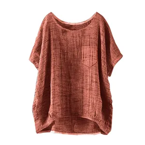 Detail view of reddish-brown loose linen top for women with a chest pocket and round neck.