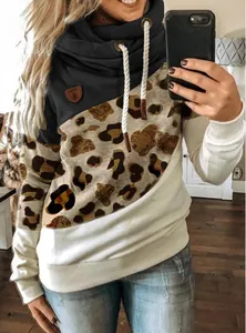 Close-up view of a stylish women's cowl neck hoodie featuring leopard print color-blocking.