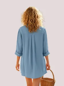 Detailed back view of a casual blue long sleeve shirt for women featuring soft pleats