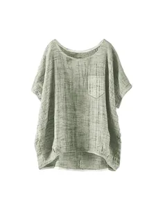 Close-up detail of a light green loose linen blend short sleeve top with a chest pocket