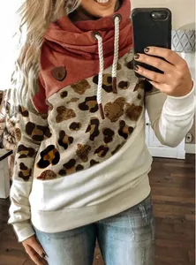 Close-up of leopard print patchwork and cowl neck on women's loose sweatshirt