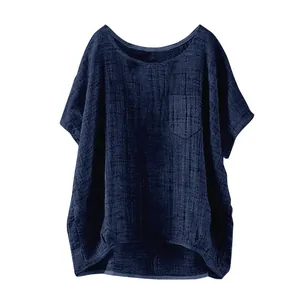 Detail of the navy blue loose linen top showing fabric texture and chest pocket