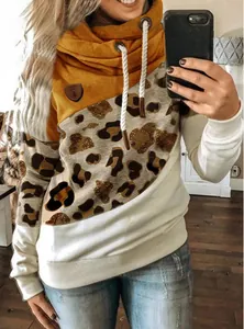 Close-up detail of women's casual color-block cowl neck hoodie with leopard print panel