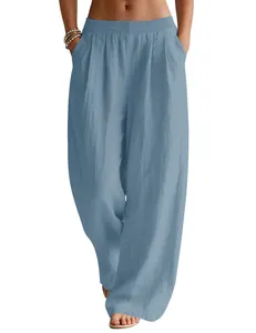 Detailed view of women's flowing linen wide-leg trousers in light blue with elastic waist
