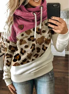 Mirror selfie showing a color block leopard print cowl neck hoodie with drawstrings.