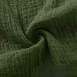 Close-up of olive green cotton linen gauze fabric with soft breathable texture