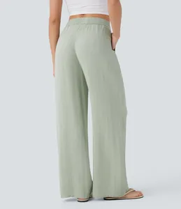 Back view of women's high-waisted sage green wide-leg linen pants with elastic waist.