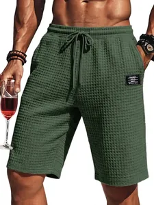 Close-up of men's green waffle texture casual shorts with elastic drawstring waist.