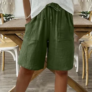 Close-up of green cotton linen shorts for women with drawstring and loose casual fit