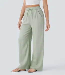 Detail shot of high-waisted linen wide-leg pants with drawstring and side pockets.