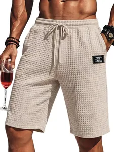 Detail of men's beige waffle knit summer shorts featuring a comfortable drawstring