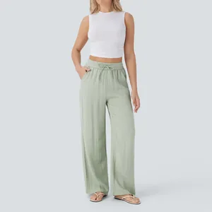Full view of light green high-waisted linen wide-leg pants with a drawstring waist.