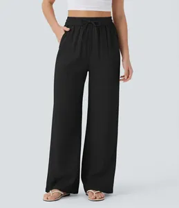 Detailed view of women's high-waisted black linen wide-leg pants with drawstring waist.