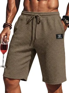 Close-up of men's waffle knit texture shorts with drawstring waist in khaki