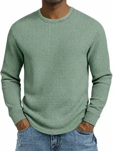 Close-up of the textured waffle knit fabric on a sage green long sleeve sweatshirt