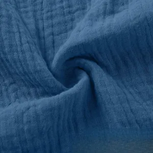 Close-up detail of soft blue crinkle cotton linen fabric texture for summer shorts
