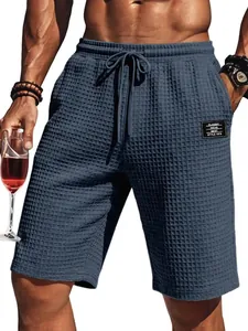 Detailed macro view showing the blue waffle knit texture of men's casual summer beach shorts
