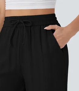 Detail view of black high waist linen pants with drawstring and side pocket