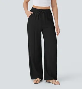 Close-up detail of women's black high waisted wide leg linen trousers with drawstring