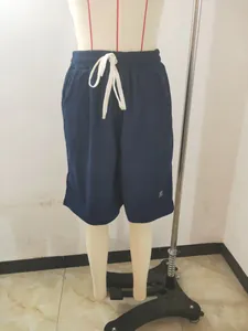 Detailed close-up view of men's navy blue waffle knit casual shorts on a mannequin