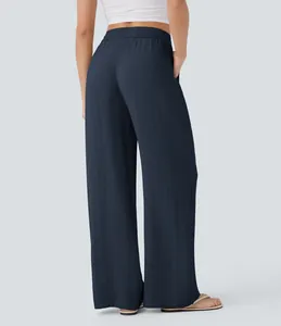 Back view of dark blue high-waist wide-leg linen-style casual beach pants with elastic waist