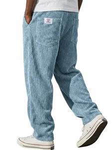 Detail view of light blue ribbed corduroy pants with a relaxed straight-leg fit.