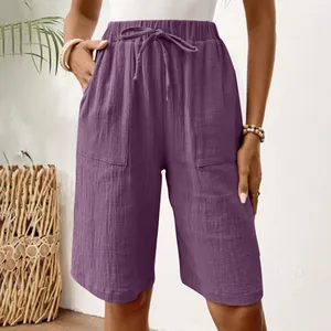 Detail view of purple women's linen shorts showing elastic drawstring waist and pockets