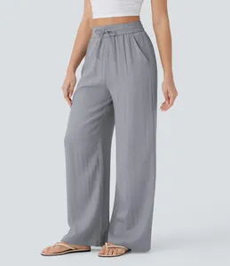 Flowy high-waisted grey linen-style wide leg trousers with drawstring and pockets