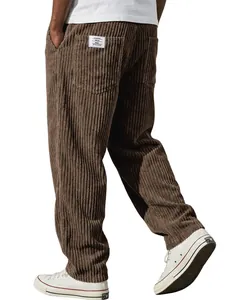 Detailed view of brown corduroy trousers featuring a back pocket patch and white sneakers