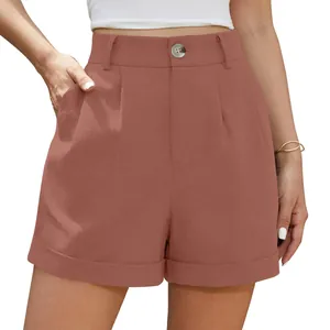 Detail view of women's terracotta high-waisted cotton linen shorts with button closure