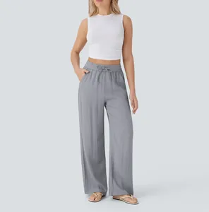 Detail shot of grey wide-leg linen pants featuring a drawstring waist and side pockets