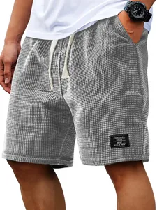 Close-up of men's gray waffle knit shorts featuring a textured fabric and drawstring.