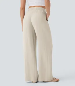 Back view detail of high-waisted wide-leg linen pants in beige showing relaxed fit