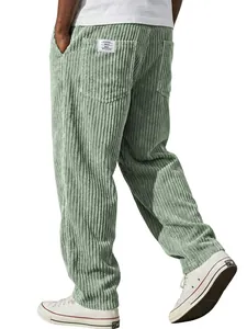 Detailed view of men's sage green corduroy pants with vertical stripes and back pocket label