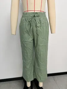 Sage green high-waisted linen trousers with elastic drawstring waist and wide legs