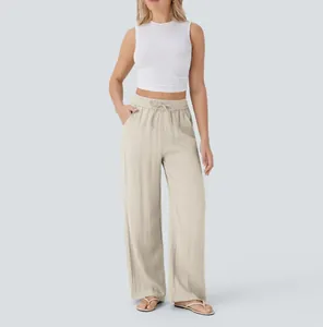 The image shows the relaxed fit and natural linen texture of these beige trousers.