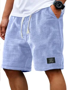 Macro detail of light blue men's waffle knit casual shorts with breathable texture.