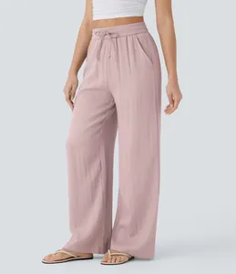 Women's dusty pink high-waist linen pants featuring a drawstring waist and wide-leg design