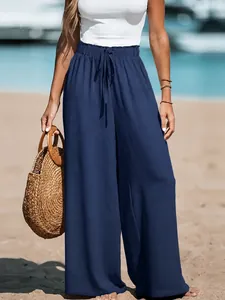 Close-up of blue cotton linen wide-leg pants with elastic drawstring waist at beach