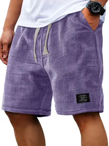 Close-up of men's purple waffle knit shorts showing fabric texture and drawstring