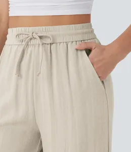 Close-up of high-waisted linen pants featuring a drawstring waist and side pockets.