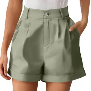 Detail view of sage green high-waisted cotton linen shorts with button and pleats