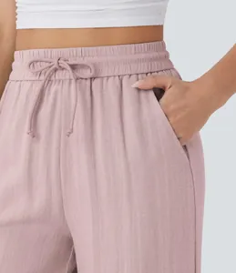 Close-up of high-waisted drawstring linen wide-leg pants showing pocket detail