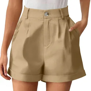 Close-up of khaki high-waisted shorts with button closure and pleated front detail.
