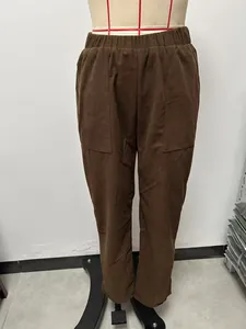 Detailed view showing the texture of brown corduroy straight leg pants with elastic waist