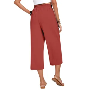 Back view of women's high-waist linen wide-leg cropped pants in brick red